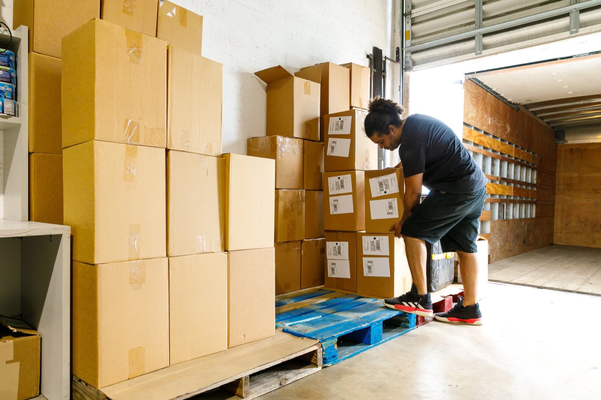 A SunPort team member labeling and packing outbound cartons